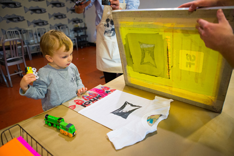 A child participating in Half Pint Prints activity at The Warhol