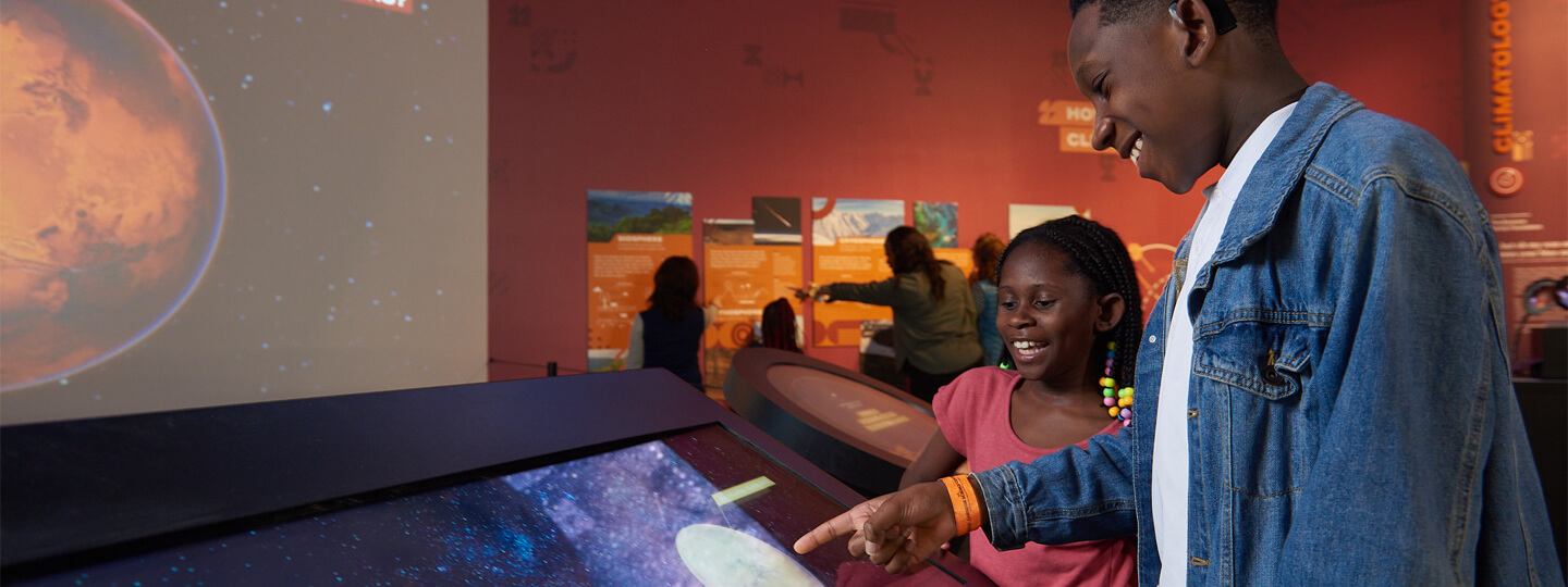 Students interacting with a touchscreen for Mars