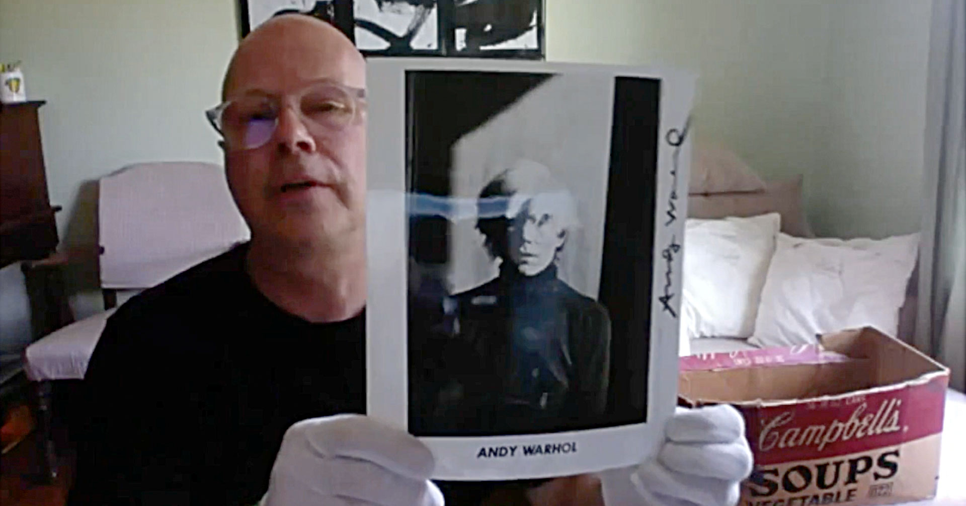 Donald Warhola holding a photo of his Uncle, Andy Warhol